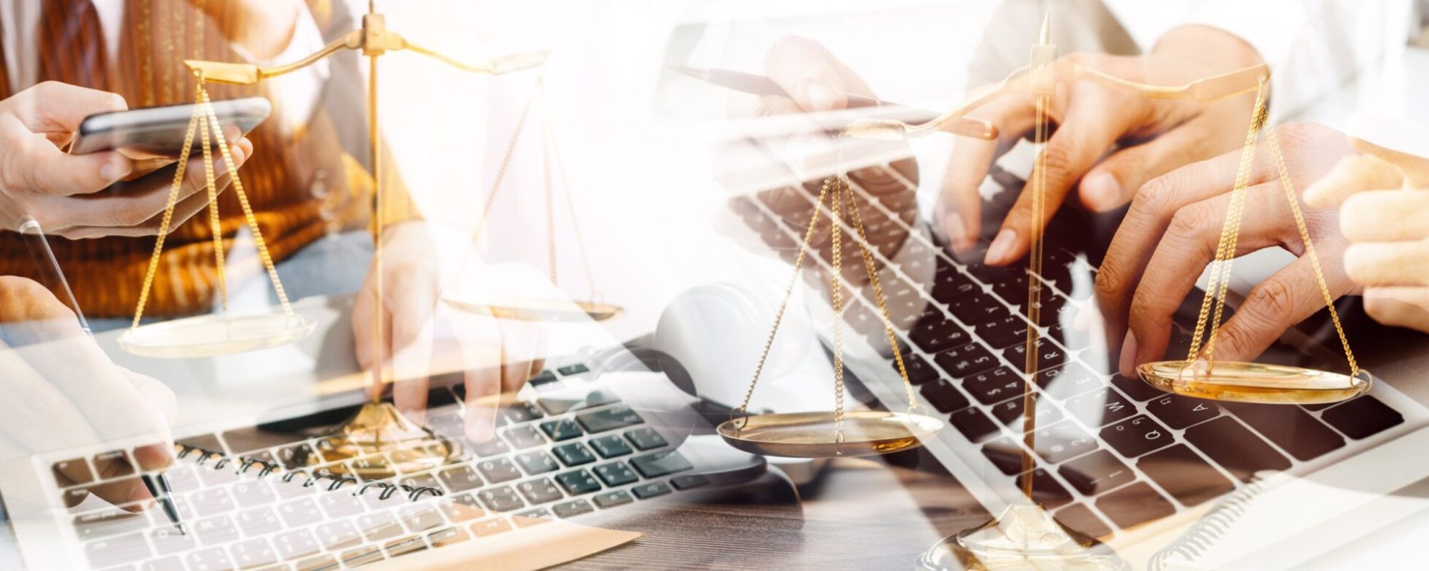 Justice and law concept.Male judge in a courtroom with the gavel, working with, computer and docking keyboard, eyeglasses, on table in morning light