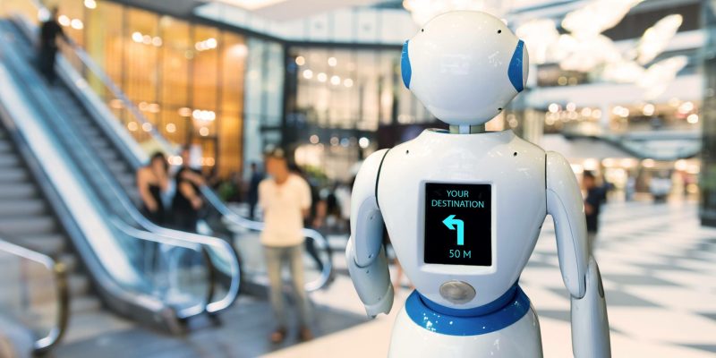 Smart retail , robot assistant , robo advisor navigation robot technology in department store. Robot walk lead to guide customer to destination target.